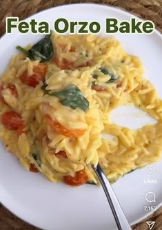 a white plate topped with pasta covered in cheese and tomato sauce next to a fork