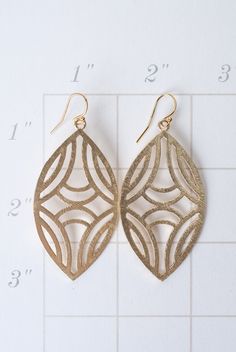 These brushed gold findings display a shield-like oval, with a tribal design. They are created with brushed gold plated brass, and dangle from gold filled earwires. Matte Gold Plated Brass (nickel and lead-safe) 2.5", with gold filled earwires We hand select our natural materials, thus there may be slight variations in color and/or size that will not detract from the overall aesthetic Our unique handcrafted designer jewelry for women is made in America, each design created individually in our pe Designer Handmade Jewellery, Oval Earrings, Gold Flats, Oval Earring, Matte Gold, Designer Jewelry, Designer Earrings, Natural Materials, Gold Earrings