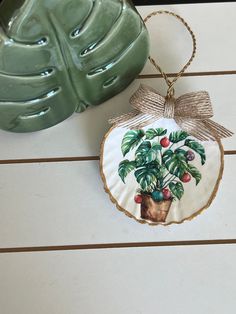 a ceramic ornament with a potted plant hanging from it's side