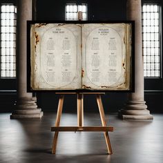 an open book sitting on top of a wooden easel