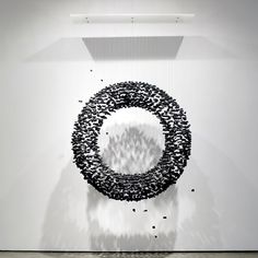 an abstract sculpture is shown in the middle of a room with white walls and flooring