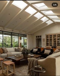 a living room filled with furniture and lots of windows