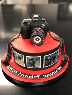 a birthday cake with a camera on top