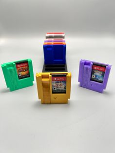 The perfect solution to organizing your switch games with a touch of nostalgia. we have the option of the base section having five or ten slots.  the color selection in the listing is for the base. make sure to add in the personalization section what colors you are wanting for the cartridges. if the personalization section is left blank, then all of the cartridges will be grey. also if you do not select enough colors, the remaining ones will be made grey.  colors available include: red blue purp Switch Game Holder, Office Desk Storage, Switch Games, Bleu Violet, Desk Storage, Storage Items, White Beige, Pink Yellow, Office Desk