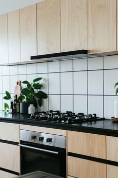 a stove top oven sitting inside of a kitchen next to a wooden cabinet and counter