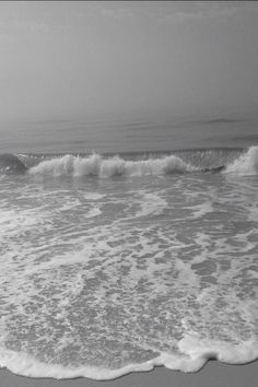 a person riding a surfboard on top of a wave in the ocean at the beach