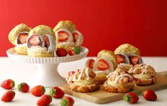 strawberry shortcakes with cream cheese frosting and strawberries on a plate next to them