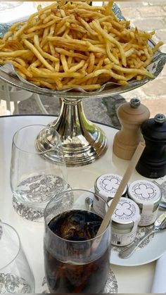 french fries on a table with wine glasses