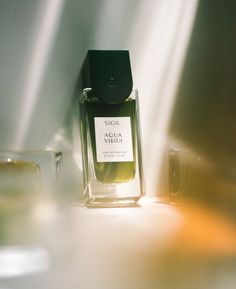 a bottle of perfume sitting on top of a table