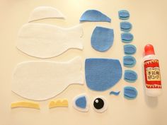 felt craft supplies laid out on a table with glue and scissors to make them look like birds