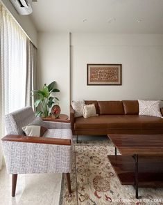 a living room filled with furniture and a large window