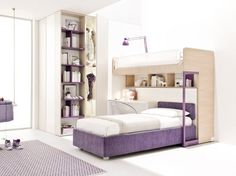 a purple and white bedroom with a bunk bed in the corner, bookshelf on the wall