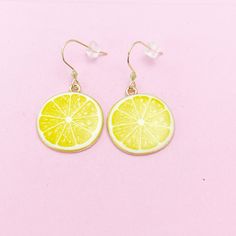 These are gold-toned lemon slice on stainless steel ear hooks. ♥ You will get one pair. HOW TO ORDER 1) Choose the quantity. 2) Choose the style in the option or add a note to seller at checkout. 3) Add to the cart. DESCRIPTION ♥ (Real 18K Gold Plated) 304 Stainless Steel Dangle Earrings, Size: about 0.67 inch(17mm) long, 0.71 inch(18mm) wide, 0.09 inch(2.4mm) thick OR ♥ (Ion Plating (IP) )304 Stainless Steel Leverback Earring Findings, with Loop, Golden, Size: about 12mm wide, 14.5mm long, 0.6mm thick, pin: 0.7mm ♥ Lemon Slice, Light Gold Alloy Enamel Pendants, Cadmium Free & Nickel Free & Lead Free, Yellow, Size: about 1.02-inch (26mm) long, 0.91-inch (23mm) wide, 0.08-inch (2mm) thick 26mm (1") x 23mm (7/8") ♥ Materials are sourced both domestically and internationally, and the final pr Enamel Pendants, Lemon Slice, Gold Alloys, Leverback Earrings, Jewelry Card, Ear Hook, Earring Findings, Oils For Skin, Charm Earrings