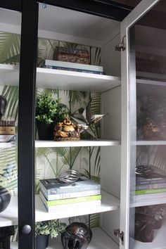 a book shelf with books and plants in it