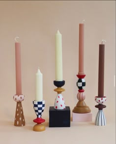 several candles are lined up next to each other in different shapes and sizes with polka dots on them