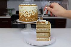 a person cutting a piece of cake with a knife