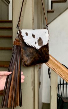 a brown and white purse hanging from the side of a stair case