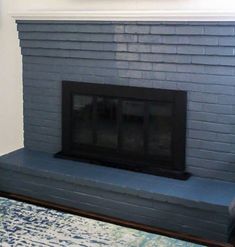 the fireplace is painted blue and has a clock above it