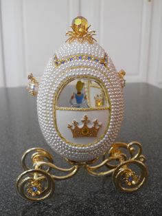 a white and gold carriage with pearls on it