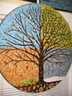 a round mosaic with a tree on it