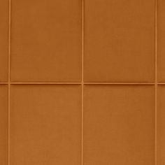 an orange tile wall with several squares in it