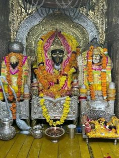 there is a statue in front of the altar with flowers on it and other decorations