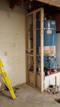 a large blue tank sitting inside of a room next to a yellow stepladder