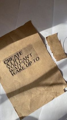 a piece of brown paper sitting on top of a white table next to a pair of scissors