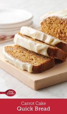 carrot cake quick bread with cream cheese frosting on a cutting board next to plates