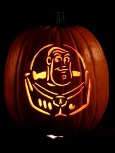 a carved pumpkin with an image of a robot on it