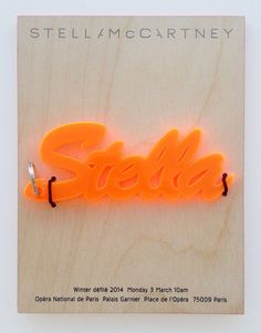 an orange neon sign that says stella on it