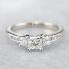 three stone engagement ring with side stones in white gold