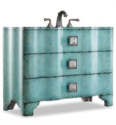 a blue dresser with metal handles and knobs on the front, against a white background