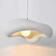 a white light hanging from a ceiling fixture