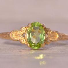 The Hove: Peridot Ring In Yellow Gold With Patterned Shank. This Delicate Ring Centers On An Oval Brilliant-Cut Natural Peridot With A Patterned Shank. The Ring Is Crafted In 14 Karat Yellow Gold And Is Currently A Finger Size 4.25 Yet Can Be Adjusted To Any Finger Size For An Additional Charge On Request. Yellow Peridot Wedding Rings, Green Rings, Peridot Ring, Delicate Rings, Emerald Ring, Womens Jewelry Rings, Green Yellow, Size 4, Yellow Gold