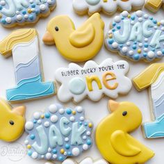 decorated cookies are arranged in the shape of ducks and one is for a baby shower