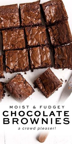 chocolate brownies cut into squares on top of a white plate with a knife next to them