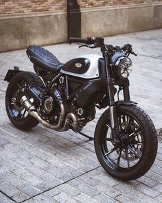 a black and white motorcycle parked on the street