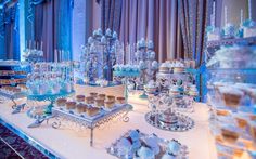 an elaborately decorated buffet table with many desserts and pastries on it's sides