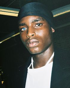 a close up of a person wearing a hat