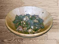 a wooden bowl filled with lots of green food