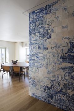 a blue and white tiled wall in a dining room