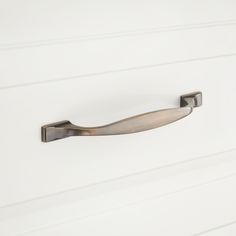 a metal handle on a white door