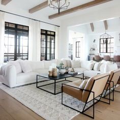 a living room filled with furniture and lots of windows