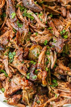 shredded beef with herbs in a white bowl