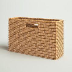 a woven basket with handles on an isolated background for use as a storage container or wall hanging