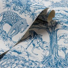 a blue and white wallpaper with an animal print on the back ground, next to a roll of tape