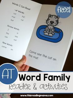 a hand holding an open book with the words word family on it and a cat reading