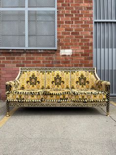 a couch sitting in front of a brick building