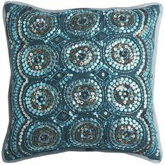 a blue and brown pillow with circles on it